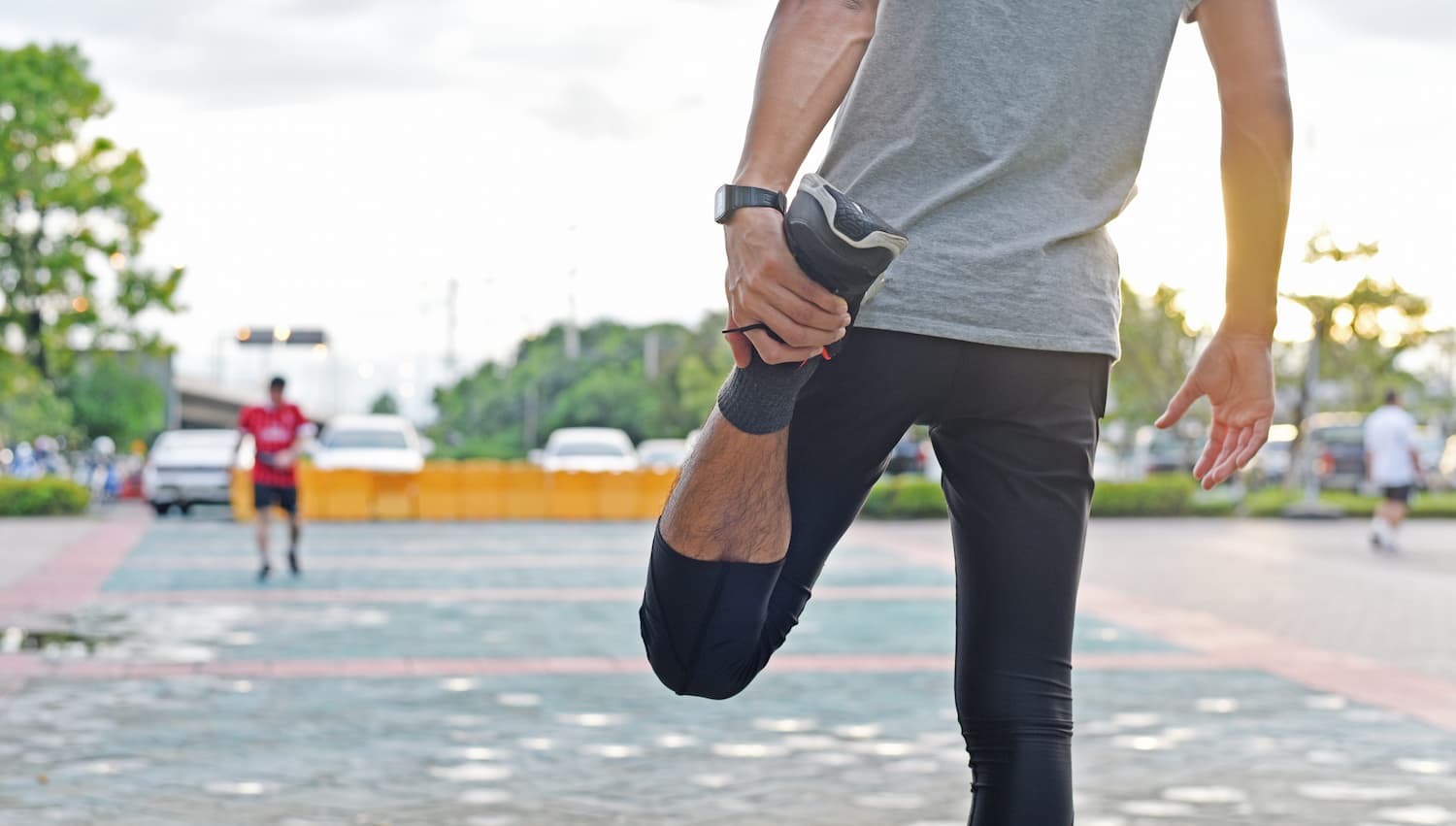 A runner stretching out his leg before a run