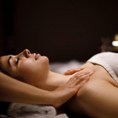 Woman enjoying massage in spa center